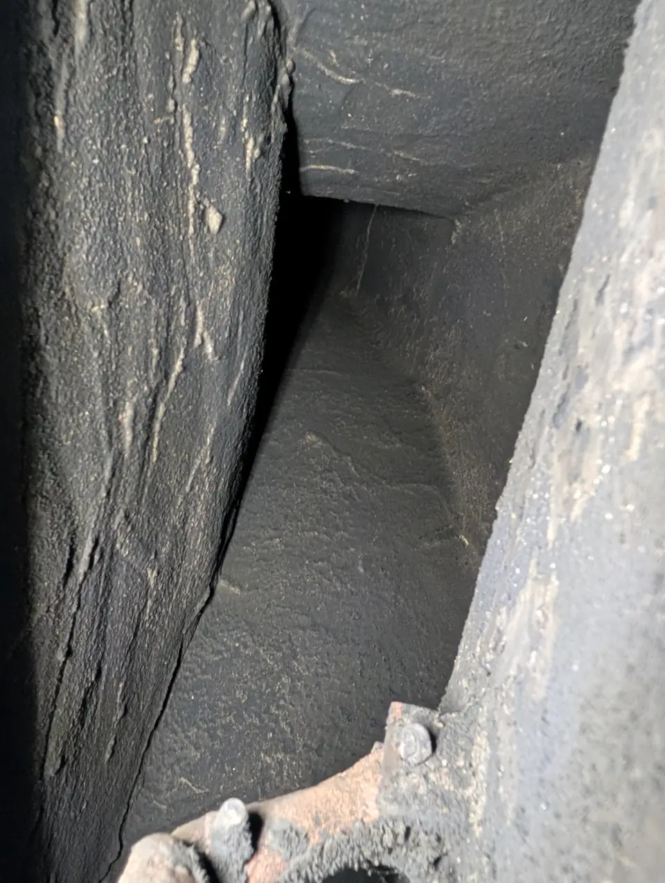 Soot-darkened firebox walls and smoke shelf